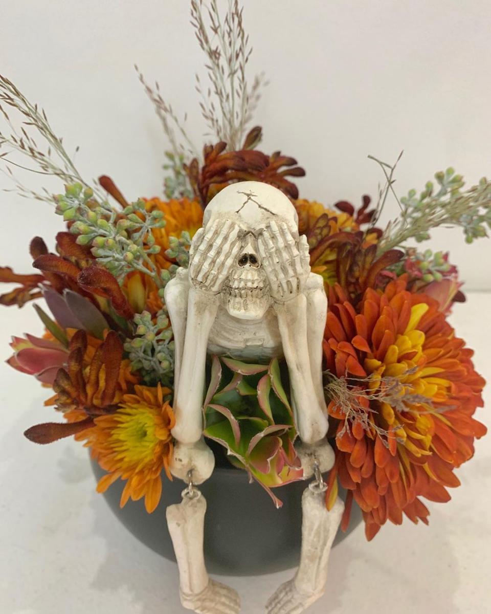 Halloween-themed fall flower arrangement